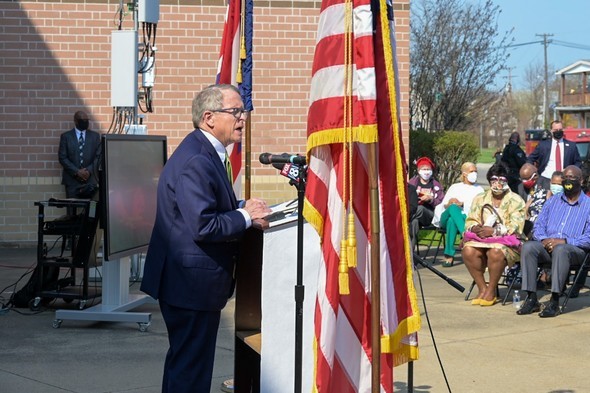 Governor Mike DeWine speaks from a podium outside Mayfair Elementary School in East Cleveland, Ohio, on Wednesday, April 7, 2021.
