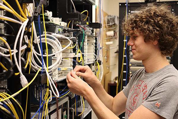 Network Install Student Assistant Caleb Schimming testing new equipment in OARnet's test lab before installing in the field.