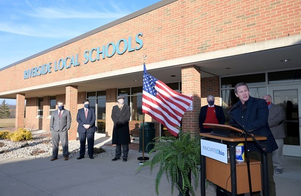 Lt. Gov. Jon Husted speaks from a podium outside a Riverside Local Schools building in Logan County, Ohio.