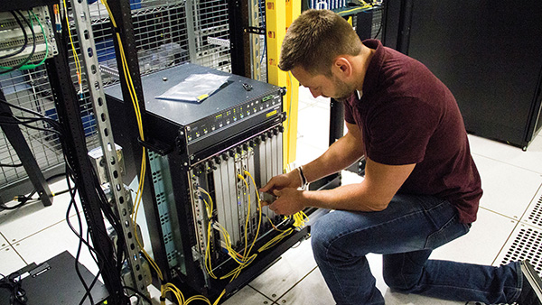 Person working on electrical connections in the field