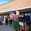 Lt. Gov. Jon Husted speaks from a podium outside a Riverside Local Schools building in Logan County, Ohio.